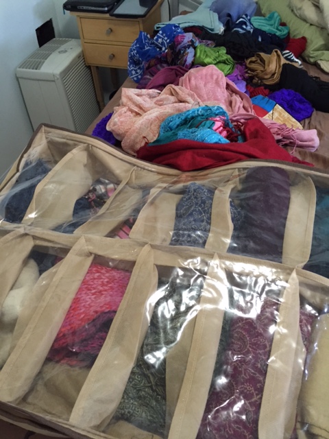 The spring scarves and the winter scarves in their under-the-bed storage container